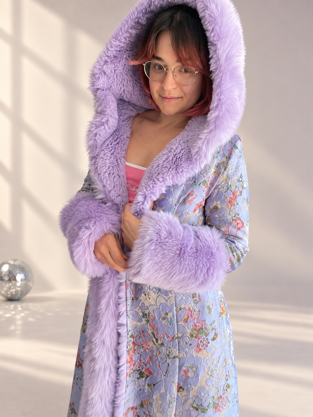 Close-up of Lilac Princess floral brocade coat with oversized lilac faux fur hood, cuffs, and front trim